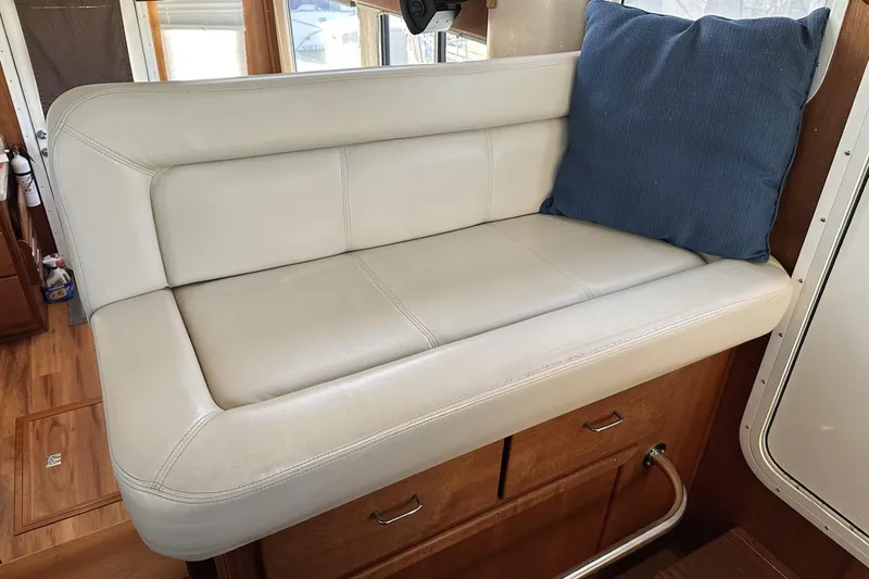 Slide: The Image of Cream leather seating with blue cushion in 2005 American Tug 34 Pilothouse interior. - 56