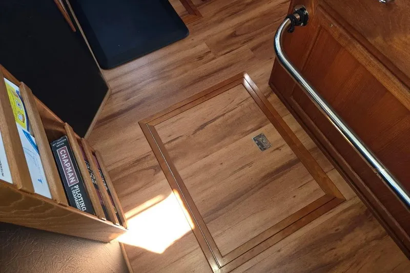 Slide: The Image of Interior of 2005 American Tug 34 Pilothouse with wooden flooring and storage compartment. - 65