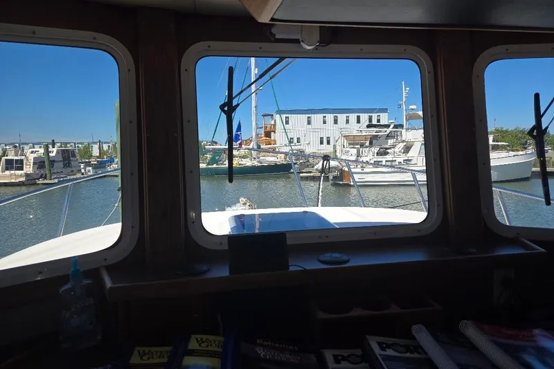 Slide: The Image of Pilothouse view from 2005 American Tug 34, overlooking marina with boats and buildings. - 66