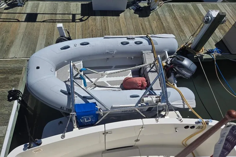 Slide: The Image of Inflatable dinghy on 2005 American Tug 34 Pilothouse, docked with Yamaha outboard motor. - 75