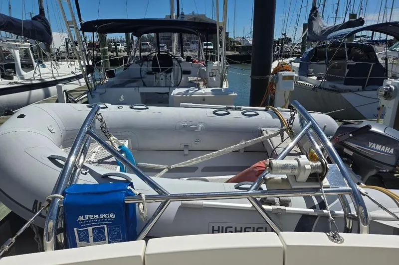 Slide: The Image of 2005 American Tug 34 Pilothouse with inflatable dinghy and Yamaha motor at marina. - 76