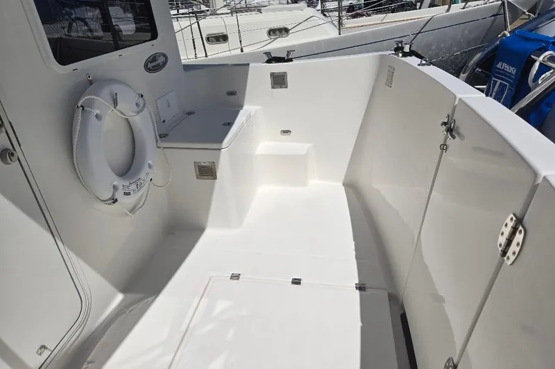 Slide: The Image of 2005 American Tug 34 Pilothouse boat deck with life preserver and seating area. - 81
