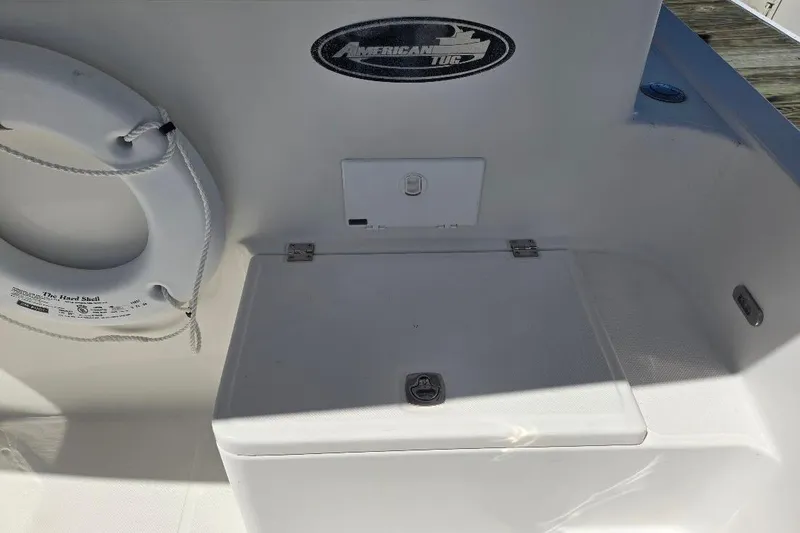 Slide: The Image of 2005 American Tug 34 Pilothouse boat deck with storage compartment and life ring. - 84
