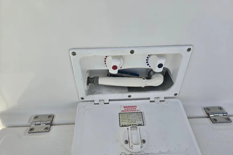 Slide: The Image of Water control panel on 2005 American Tug 34 Pilothouse boat, featuring hot and cold knobs. - 86