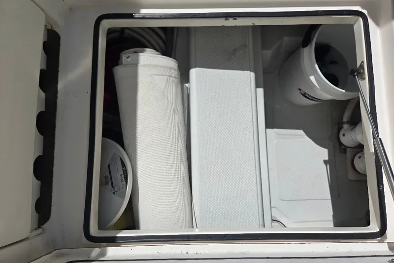 Slide: The Image of Storage compartment on a 2005 American Tug 34 Pilothouse boat with various items. - 87