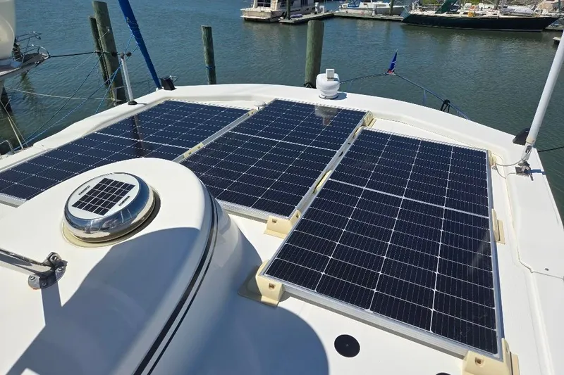 Slide: The Image of 2005 American Tug 34 Pilothouse with solar panels on deck, docked at marina. - 91