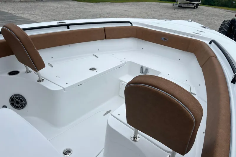 Slide: The Image of 2026 Sea Hunt Ultra 255 SE boat interior with brown seating and white deck. - 10