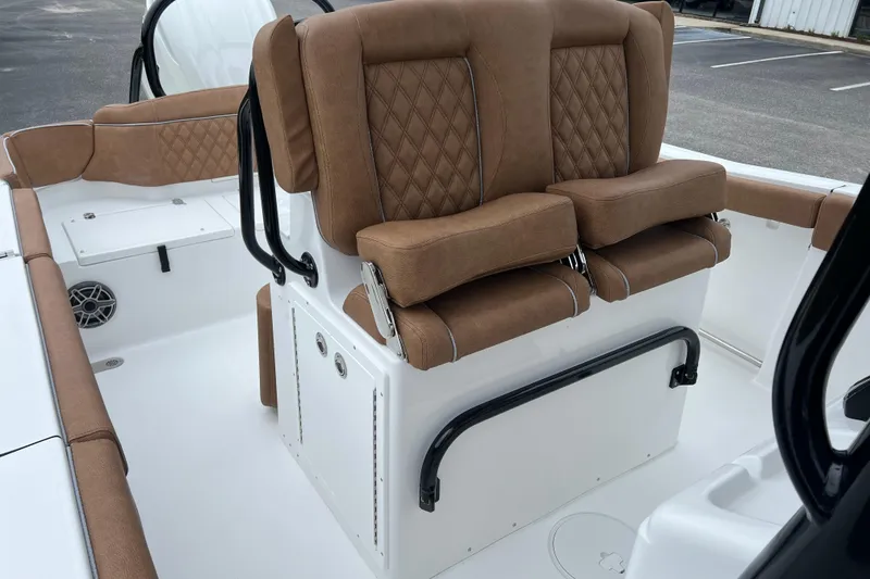 Slide: The Image of 2026 Sea Hunt Ultra 255 SE boat interior with brown cushioned seating. - 11