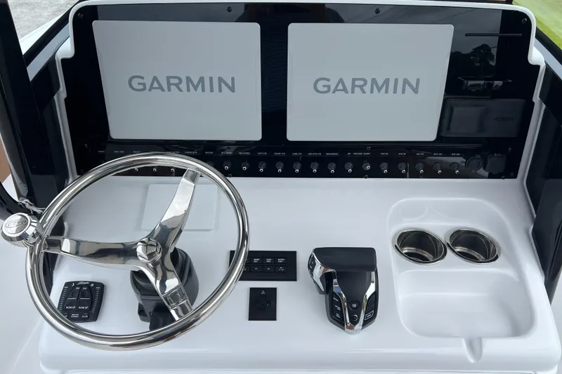 Slide: The Image of 2026 Sea Hunt Ultra 255 SE dashboard with Garmin displays and steering wheel. - 15