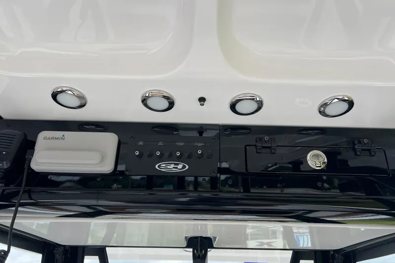 Slide: The Image of 2026 Sea Hunt Ultra 255 SE dashboard with Garmin equipment and control panel. - 16