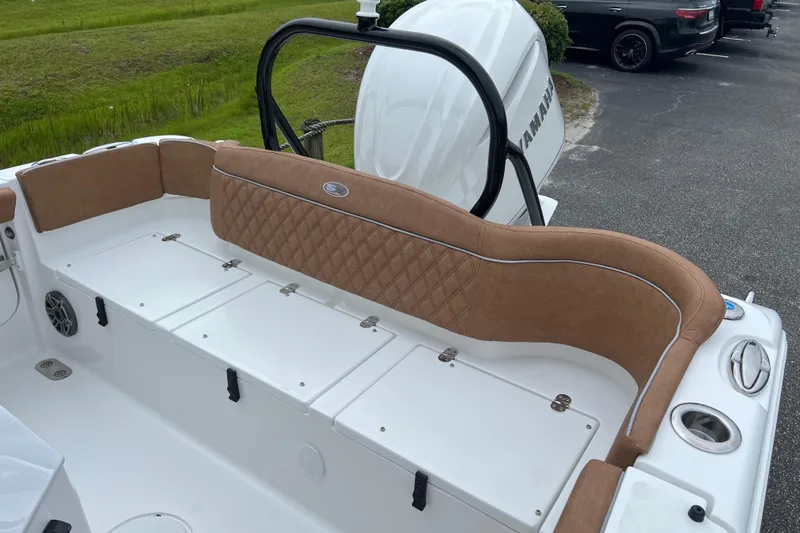Slide: The Image of 2026 Sea Hunt Ultra 255 SE boat interior with tan cushioned seating and storage compartments. - 17