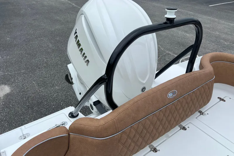 Slide: The Image of 2026 Sea Hunt Ultra 255 SE boat with Yamaha engine and tan seating. - 18