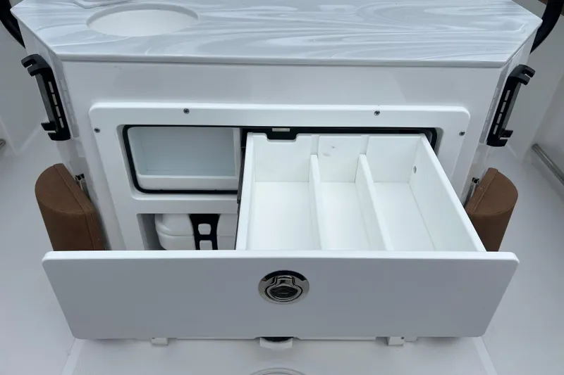 Slide: The Image of Open storage compartment on 2026 Sea Hunt Ultra 255 SE boat, featuring organized interior. - 20