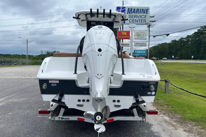 Slide: The Image of 2026 Sea Hunt Ultra 255 SE boat at Marine Service Center, featuring powerful outboard motor. - 7