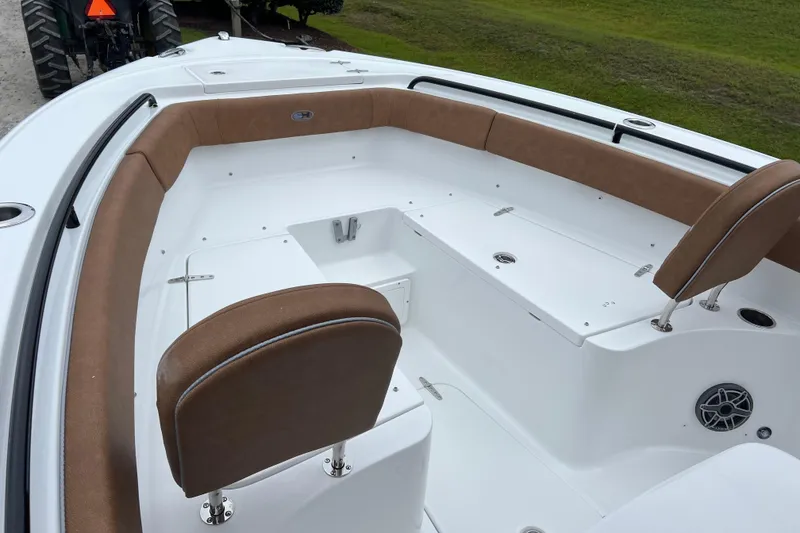 Slide: The Image of 2026 Sea Hunt Ultra 255 SE boat interior with brown seating and white deck. - 9