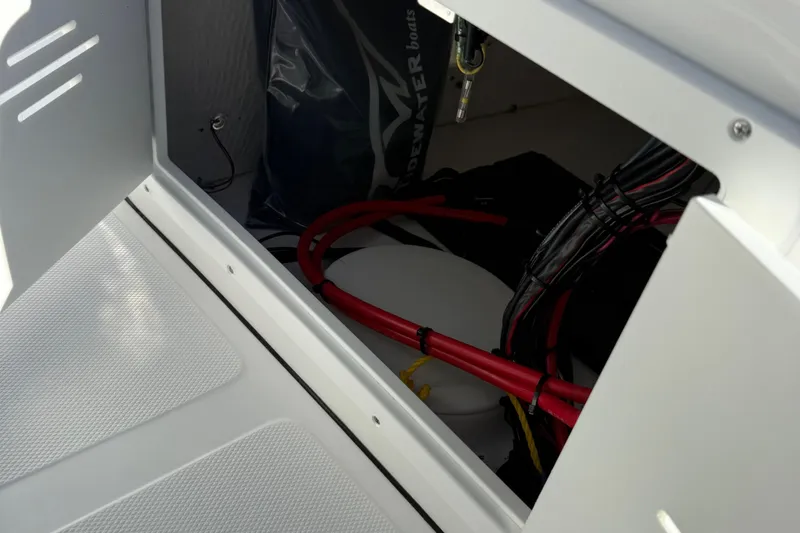 Slide: The Image of Open storage compartment on 2026 Tidewater 180CC boat with visible contents. - 16
