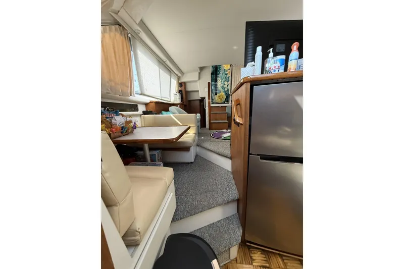 Slide: The Image of Interior of 1993 Carver 350 Motor Yacht with dining area and kitchenette. - 11