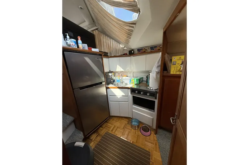 Slide: The Image of Kitchen area of a 1993 Carver 350 Motor Yacht with appliances and storage. - 12