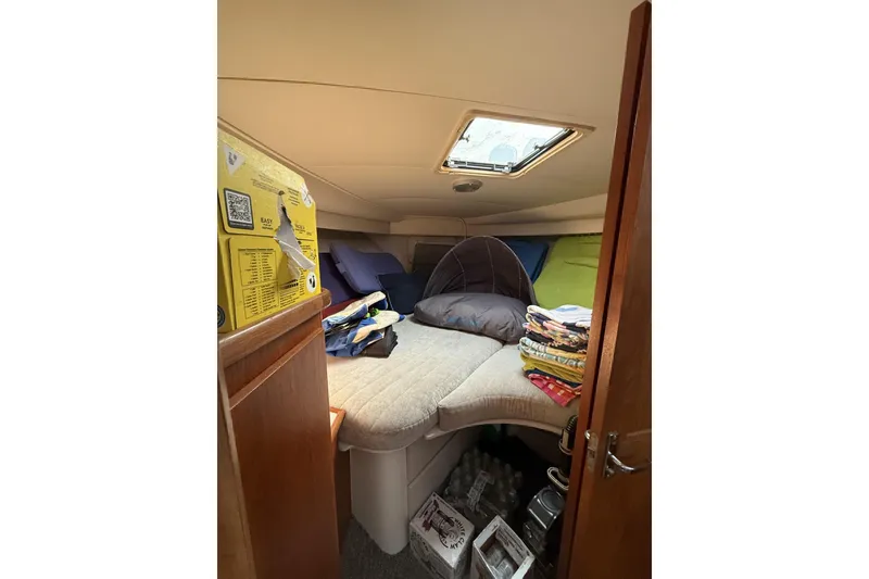 Slide: The Image of Interior cabin of 1993 Carver 350 Motor Yacht with bedding and storage. - 17