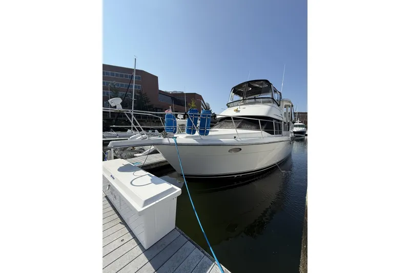 Slide: The Image of 1993 Carver 350 Motor Yacht docked at marina under clear blue sky. - 2