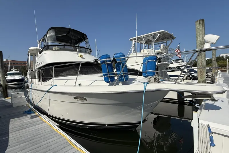 The Image of 1993 Carver 350 Motor Yacht docked at marina under clear blue sky. - 0
