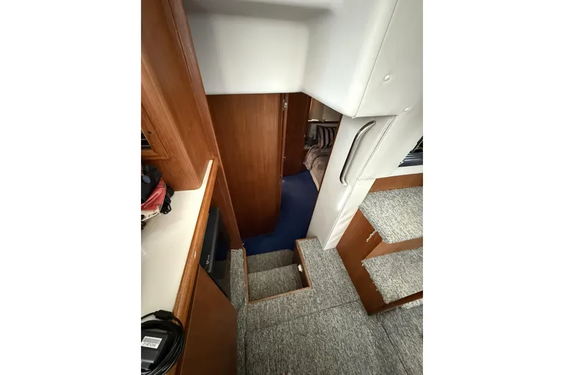 Slide: The Image of Interior view of 1993 Carver 350 Motor Yacht, featuring carpeted stairs and wooden cabinetry. - 14