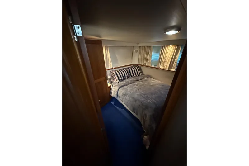 Slide: The Image of Cozy bedroom in 1993 Carver 350 Motor Yacht with striped pillows and curtains. - 15