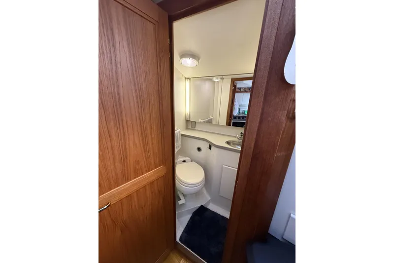 Slide: The Image of Bathroom interior of 1993 Carver 350 Motor Yacht with wooden door and compact design. - 16