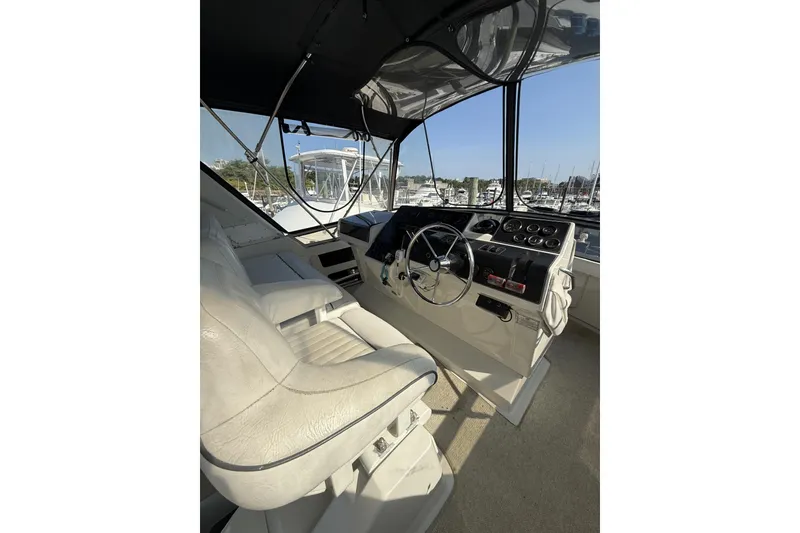 Slide: The Image of Interior helm of 1993 Carver 350 Motor Yacht with steering wheel and controls. - 5