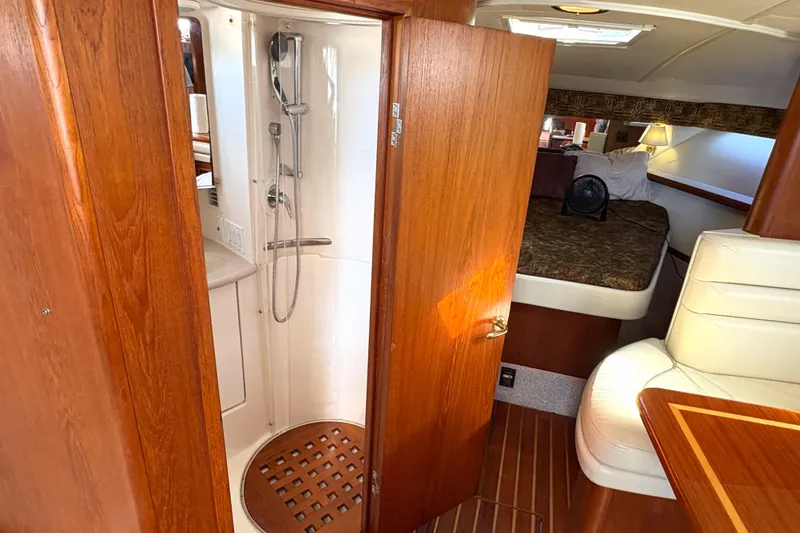 Slide: The Image of 2002 Pursuit 3800 Express yacht interior with shower, bed, and seating area. - 10