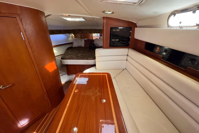 Slide: The Image of Luxurious interior of a 2002 Pursuit 3800 Express yacht with wood and leather finishes. - 12