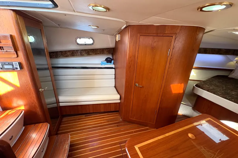 Slide: The Image of Interior of 2002 Pursuit 3800 Express yacht with wood finish and seating area. - 13