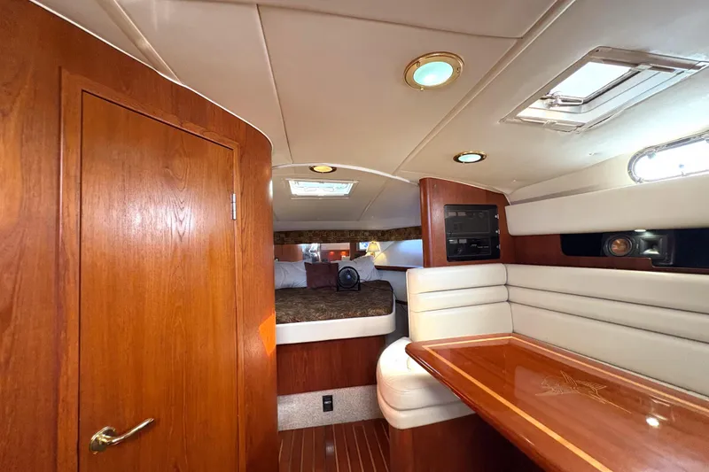 Slide: The Image of Luxurious interior of 2002 Pursuit 3800 Express yacht with wood finishes and cozy seating. - 14