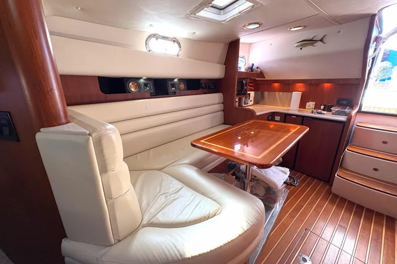 Slide: The Image of Luxurious interior of a 2002 Pursuit 3800 Express yacht with elegant seating and wooden table. - 15