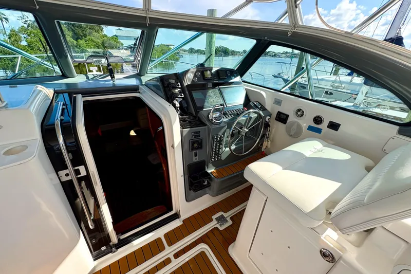 Slide: The Image of 2002 Pursuit 3800 Express boat cockpit with steering wheel and navigation equipment. - 17