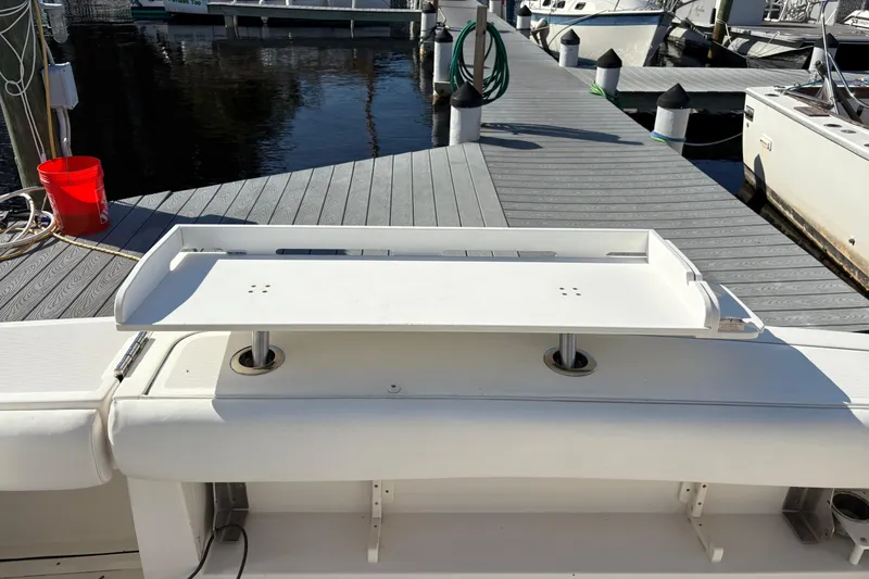 Slide: The Image of 2002 Pursuit 3800 Express boat at dock with white deck and fishing station. - 19