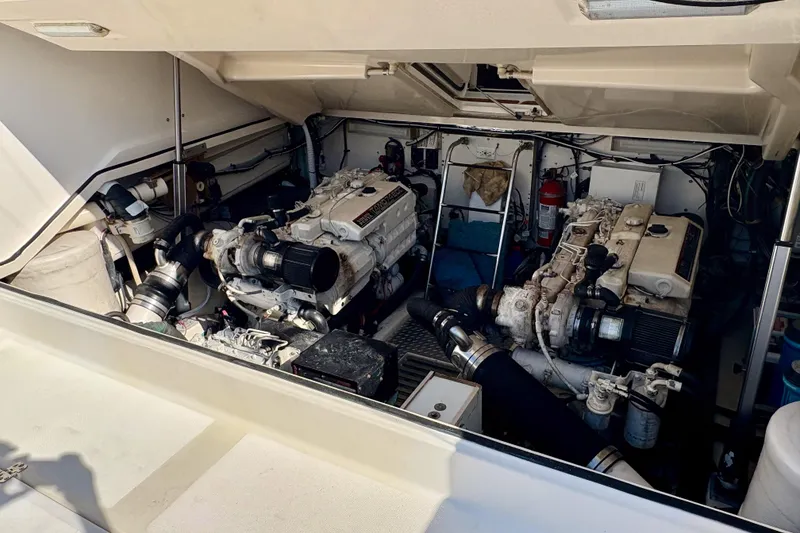Slide: The Image of Engine room of a 2002 Pursuit 3800 Express boat, showcasing dual engines and equipment. - 20