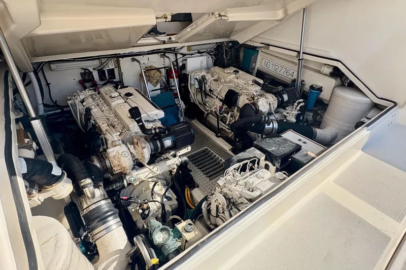Slide: The Image of Engine room of a 2002 Pursuit 3800 Express boat, showcasing dual engines. - 21