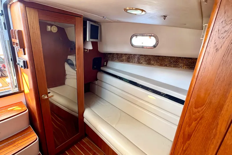 Slide: The Image of Interior of 2002 Pursuit 3800 Express boat with wooden accents and white seating. - 9