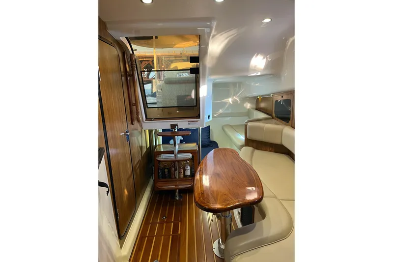 Slide: The Image of Interior of 2009 Pursuit OS 375 Offshore boat with wood accents and seating area. - 10