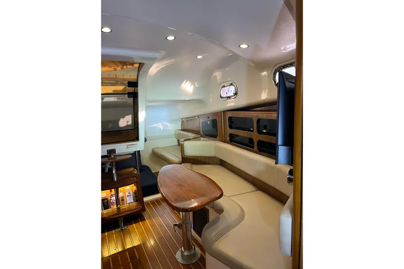 Slide: The Image of Luxurious interior of 2009 Pursuit OS 375 Offshore boat with elegant seating and wooden accents. - 11