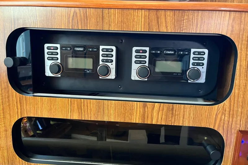 Slide: The Image of 2009 Pursuit OS 375 Offshore boat stereo system with wood paneling. - 12