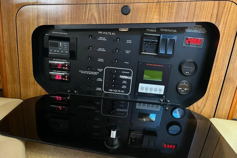 Slide: The Image of Control panel of a 2009 Pursuit OS 375 Offshore boat, featuring various switches and gauges. - 13