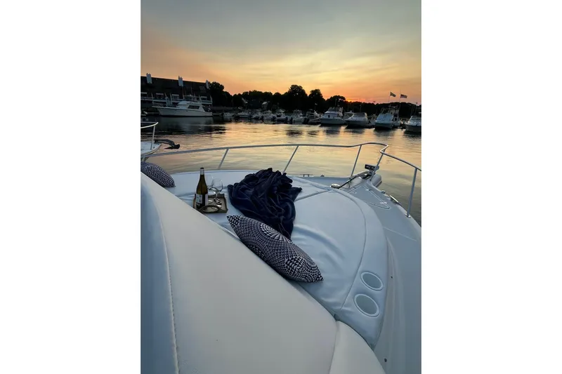 Slide: The Image of 2009 Pursuit OS 375 Offshore yacht at sunset with wine and pillows on deck. - 17
