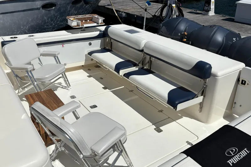 Slide: The Image of 2009 Pursuit OS 375 Offshore boat interior with seating and deck details. - 21