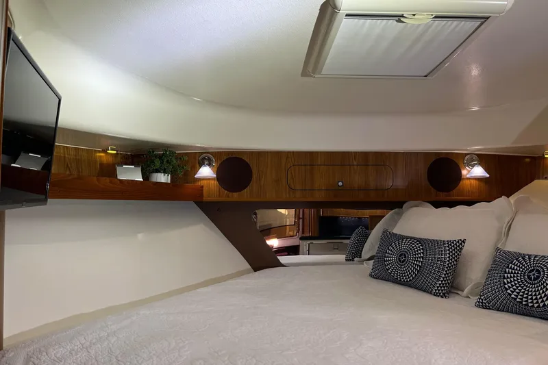 Slide: The Image of Luxurious cabin interior of 2009 Pursuit OS 375 Offshore with cozy bedding and modern lighting. - 6