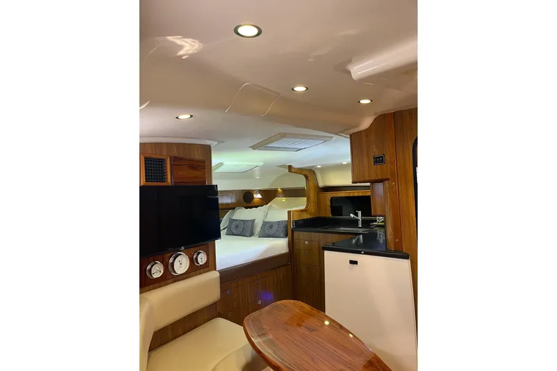 Slide: The Image of Luxurious interior of 2009 Pursuit OS 375 Offshore boat with cozy bed and modern amenities. - 7