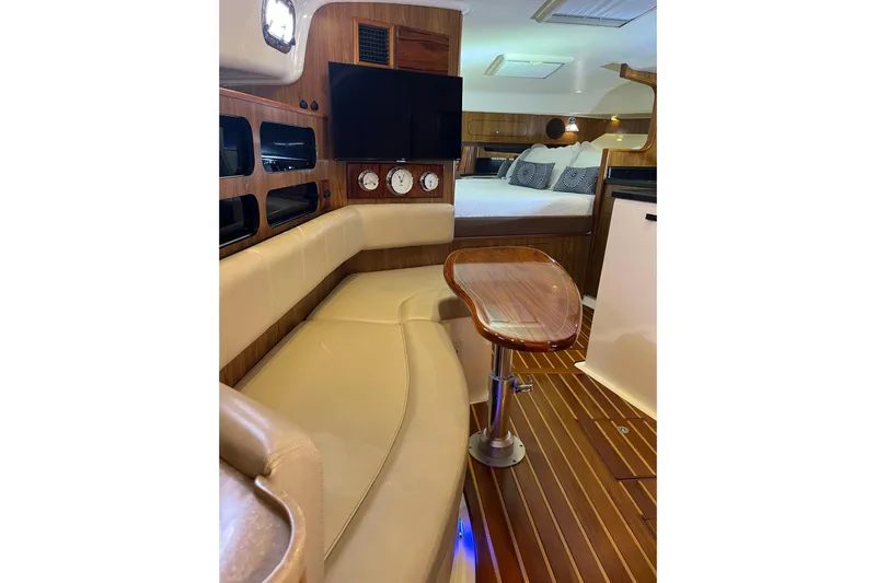 Slide: The Image of Luxurious interior of 2009 Pursuit OS 375 Offshore boat with wood accents and cozy seating. - 9