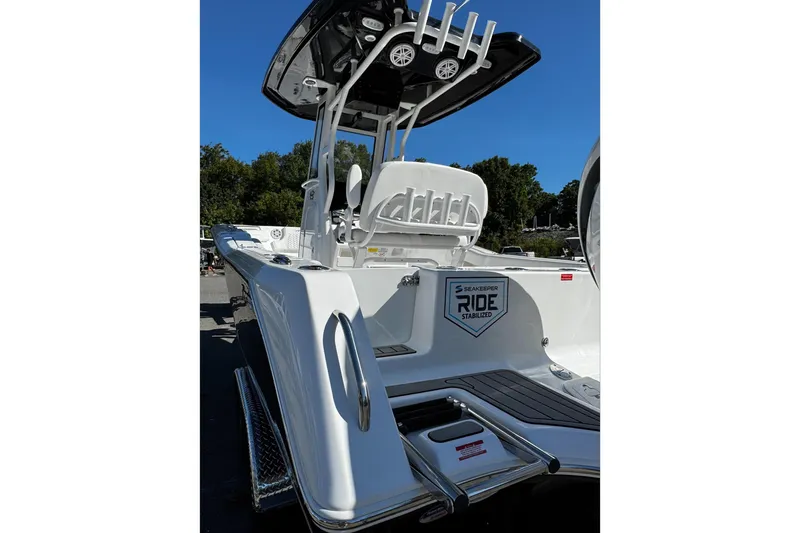 Slide: The Image of 2026 Tidewater 232 CC Adventure with Yamaha outboard motor, parked outdoors. - 10