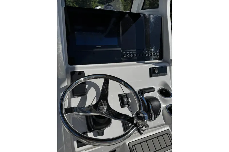 Slide: The Image of 2026 Tidewater 232 CC Adventure boat interior with seating and speakers. - 14
